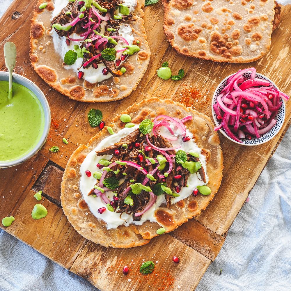 SLOW COOKED MOORISH STYLE LAMB SHOULDER ON FLATBREAD WITH PICKLED RED ONIONS