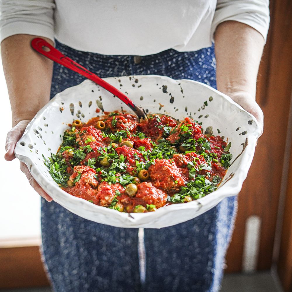 KATRINA MEYNINK HOLDING CHICKEN, KALE AND FETA DUMPLINGS WITH SICILIAN OLIVES