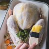 A whole turkey being basted